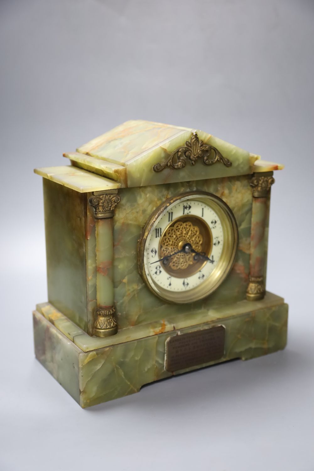 A late 19th century onyx cased eight day mantel clock, French gong-striking movement, presented 1903, 26cm wide